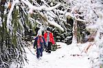 Girls walking through winter forest