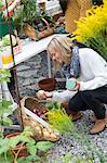 Young woman looking at home-grown vegetables