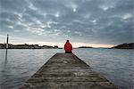 Man on jetty looking at view