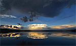 Clouds reflected in the calm waters of Kenosee lake.