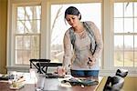 A woman setting the table for a meal.