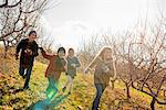 Four children running outdoors in winter