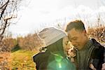 Two people, a couple walking in an orchard in winter.