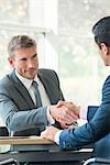 Businessmen shaking hands in meeting