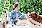 Young woman relaxing outdoors with dog