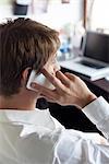 Office worker using cell phone, side view