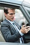 Man reading text message while driving