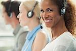 Woman working in call center, smiling cheerfully