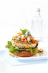 Open-faced, buffalo chicken burger with blue cheese on plate, studio shot on white background