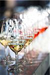 Close-up of a row of stemware, wine glasses with white and rose wine, at an event, Canada