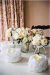 Small baskets of rose petals and bridal bouquets in vases on table, Wedding Day preparations, Canada