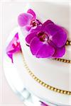 Close-up of Wedding cake decorated with fushia orchids, Canada