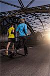 Friends jogging on bridge, Munich, Bavaria, Germany