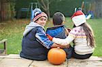 Siblings sitting on steps in garden