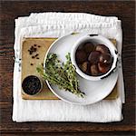 Chestnuts, plate, thyme, book, black pepper, kitchen towel