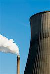 Top of smoke stack and cooling tower with blue sky