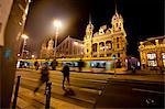 Tram And People Crossing In Front Of Budapest Western Railway Station At Night, Budapest, Hungary