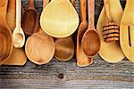 Horizontal Frame of Various Wooden Spoons and Cooking Utensils isolated on Rustic Wooden background