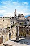 panoramic view of tipical water dispenser and church of Matera under blue sky. Basilicata, Italy