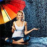 beautiful girl with umbrella under rain, black background