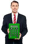 Young businessman showing big green calculator to camera isolated on white
