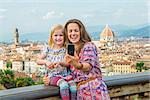 Happy mother and baby girl making selfie against panoramic view of florence, italy