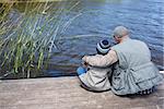 Father and son at a lake in the countryside