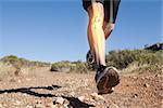 Digital composite of Highlighted leg bones of jogging man