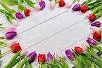 Tulips forming frame on wooden table