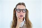 Female geeky hipster looking confused on white background