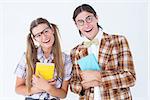 Geeky hipsters smiling at camera on white background