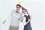 Geeky hipster couple wearing a party hat on white background