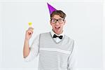 Geeky hipster in party hat with horn on white background