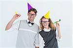 Geeky couple with party hat and party horn on white background