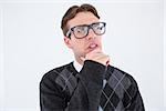 Geeky hipster thinking with hand on chin on white background