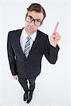 Geeky hipster businessman with finger up on white background