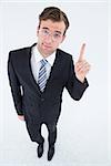 Geeky businessman with finger up on white background