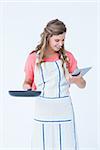 Happy hipster woman holding laptop and frying pan on white background