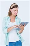 Pretty hipster using tablet on white background