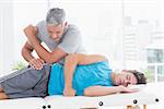 Doctor examining his patient pelvis in medical office