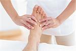 Physiotherapist doing foot massage in medical office