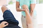 Doctor examining man arm in medical office