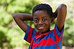 Cute little boy smiling at camera on a sunny day