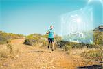 Athletic man jogging on country trail against fitness interface