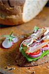 Fresh sandwiches with ham and vegetables on old wood