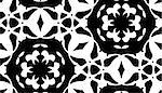 Seamless background pattern of white doily pattern over black