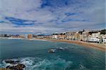 Coastline and View on Apartment Buildings and House Facades on Cloudy Blue Sky background, Blanes, Spain