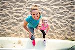 Portrait of healthy mother and baby girl on beach