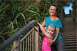 Portrait of healthy mother and baby girl outdoors in the evening