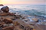 beautiful sunrise landscape,  the rocky sea coast and water waves